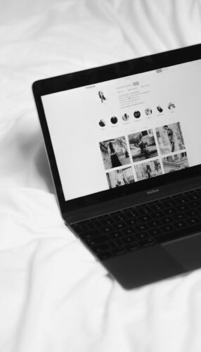 Open laptop on a white cloth backround