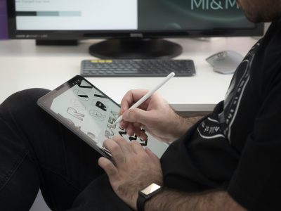 Designer drawing on a tablet with a stylus to create digital artwork